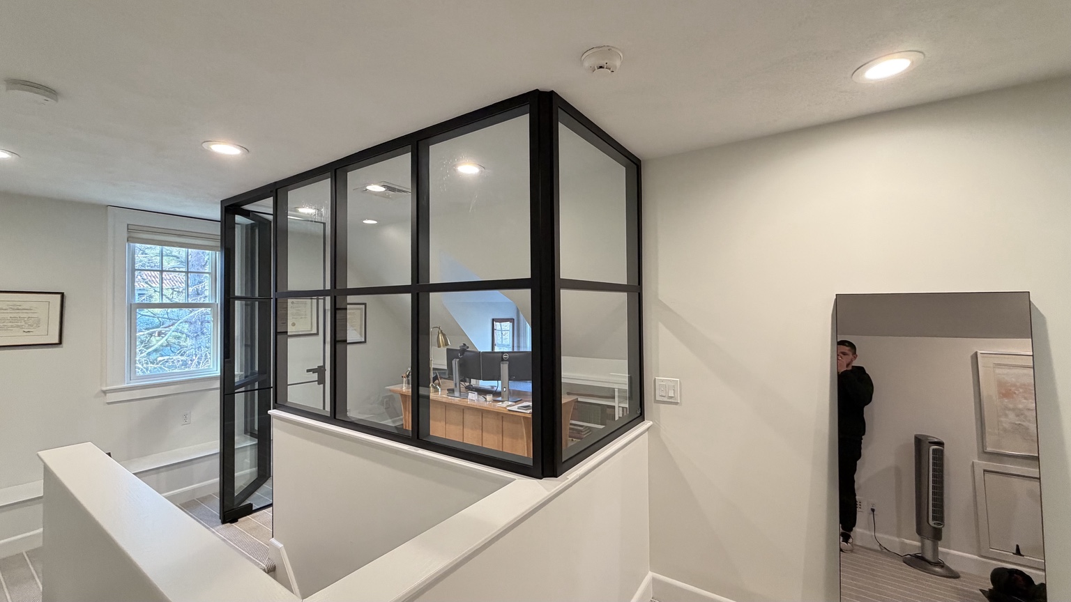 Black framed corner office enclosure with glass door