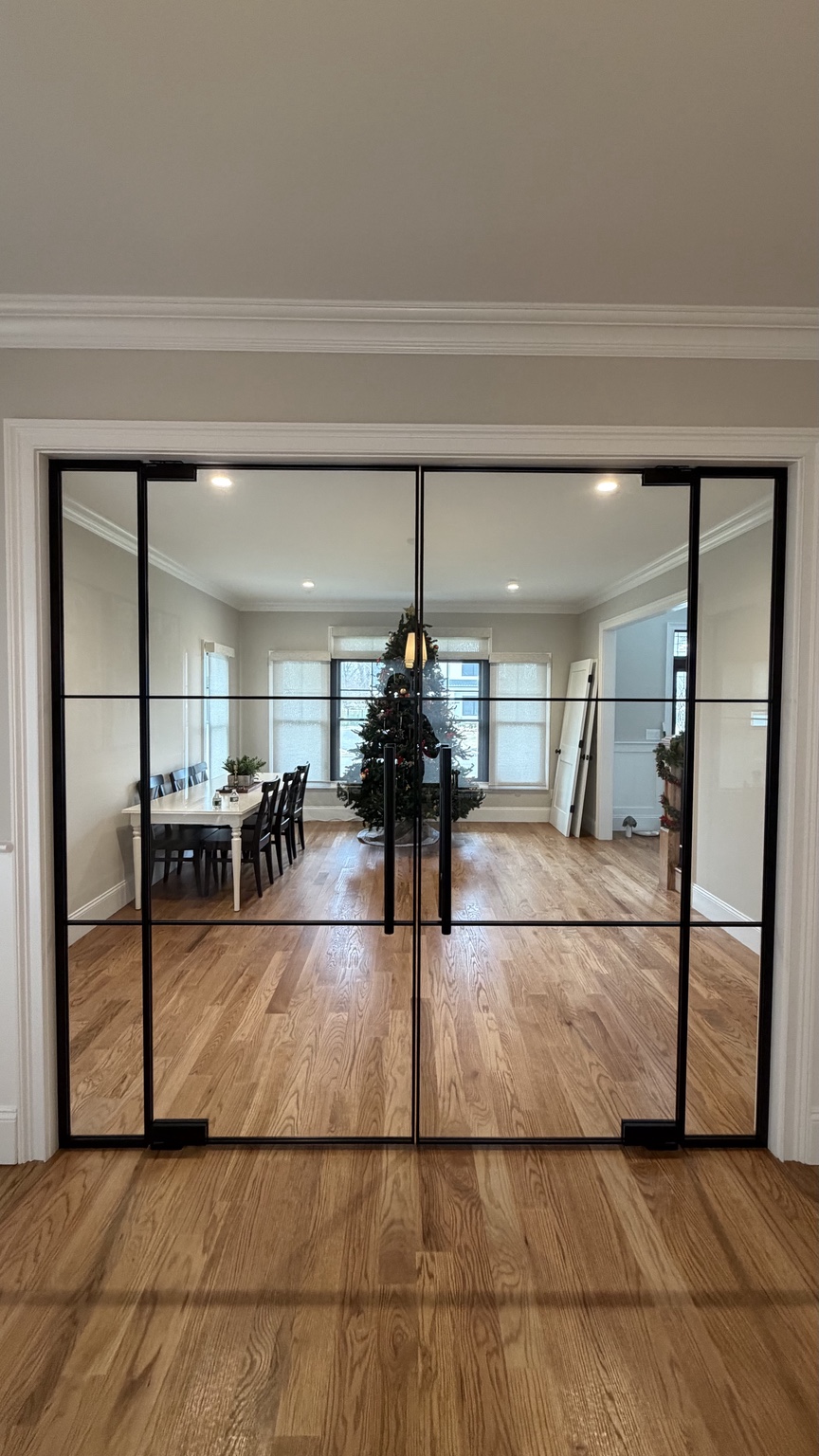 Double clear glass pivot doors in slim black frames