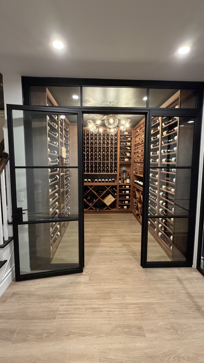 Custom black framed glass entrance to a wine cellar